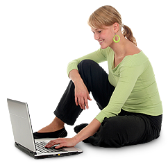Image of a woman sitting on the floor looking at a laptop