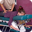 Image of a woman on a massage bed receiving treatment.